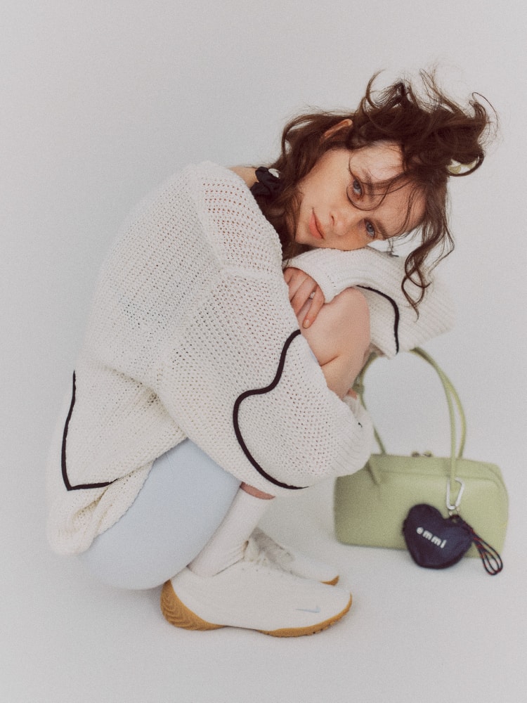 白いトップスに白のパンツを履いた女性の画像