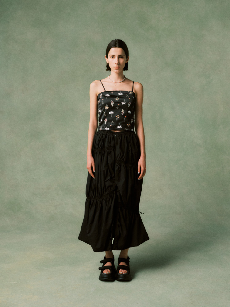 白いトップスにハーフパンツを履いた女性の画像